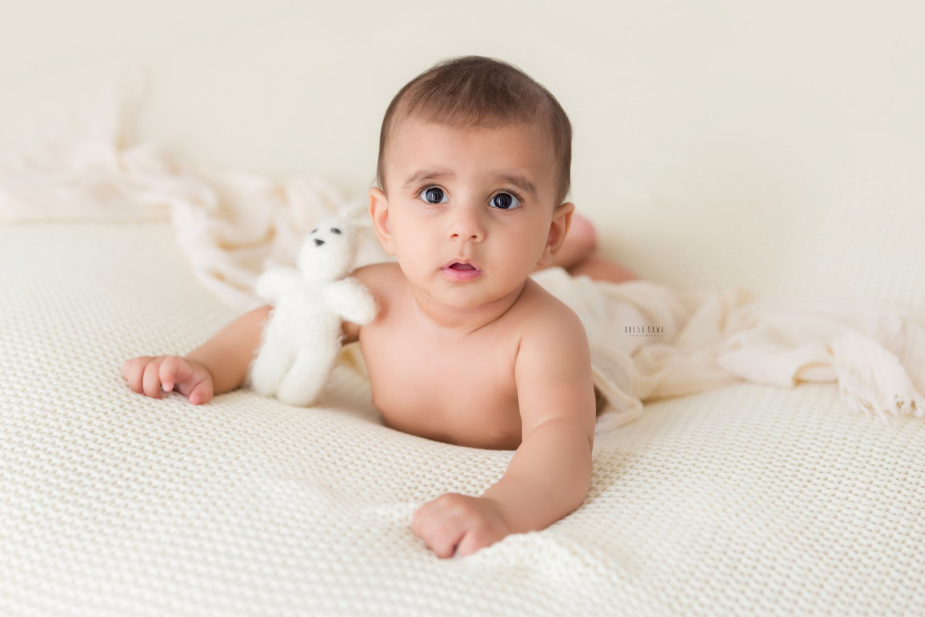 Baby boy photo shoot, 6 or 5 or 3 or 4 months, white sheet, soft toy, white backdrop. Location: Delhi, Gurgaon, Noida. Photographer: Anega Bawa.