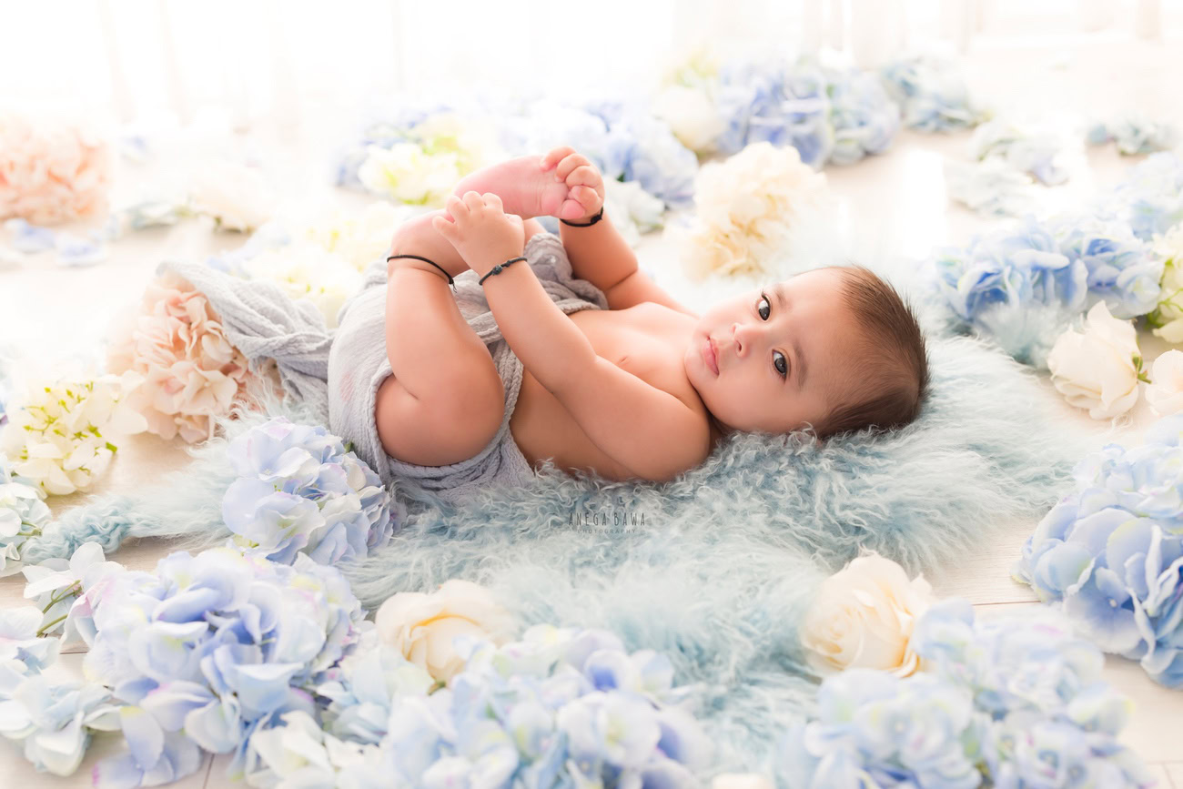 Baby boy photographer, 6 or 4 or 3 or 5 months, blue flowers, blue rug. Location: Delhi, Gurgaon, Noida. Photographer: Anega Bawa.