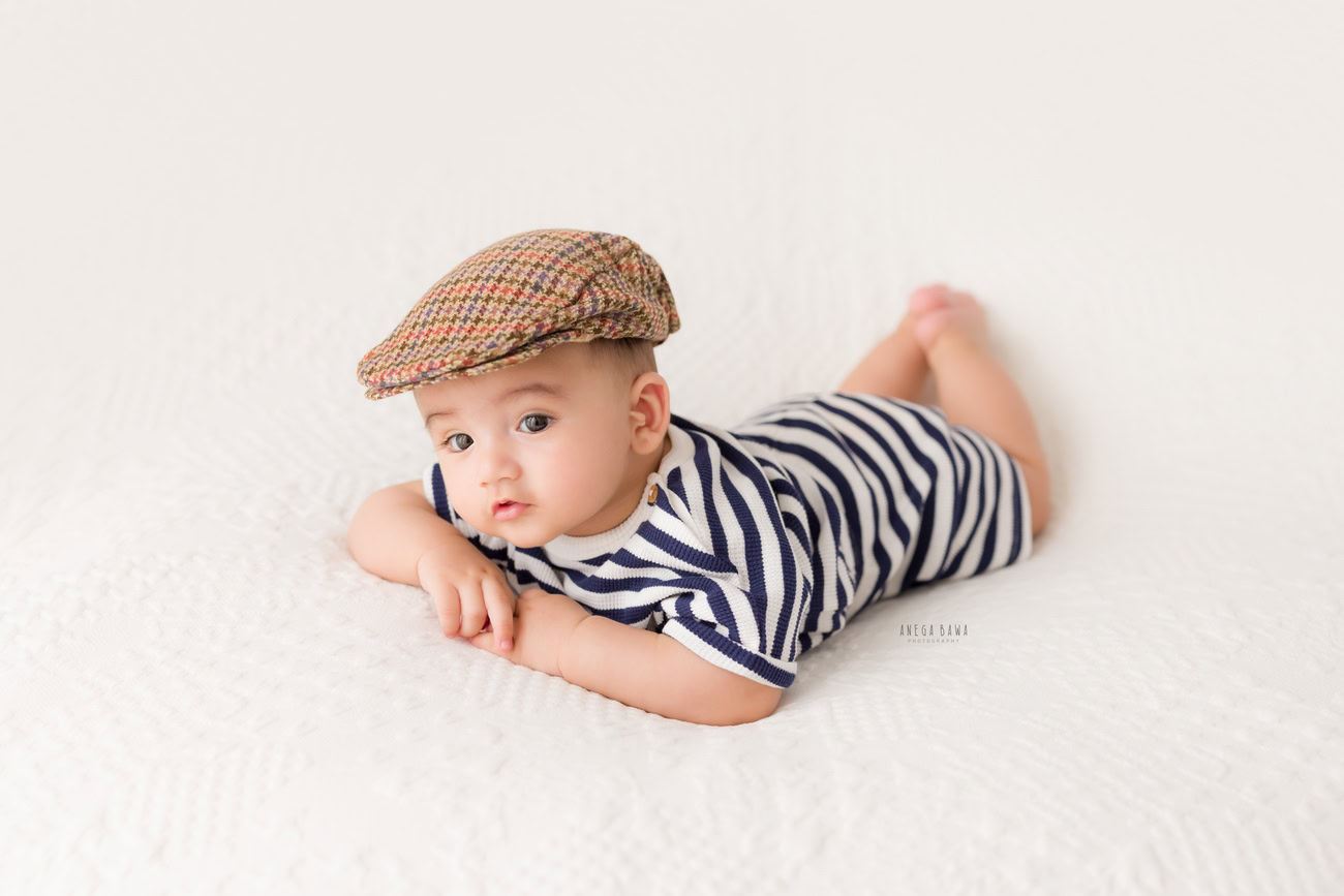 Baby boy photographer, 6 or 4 or 3 or 5 months, Burberry cap, white backdrop. Location: Delhi, Gurgaon, Noida. Photographer: Anega Bawa.