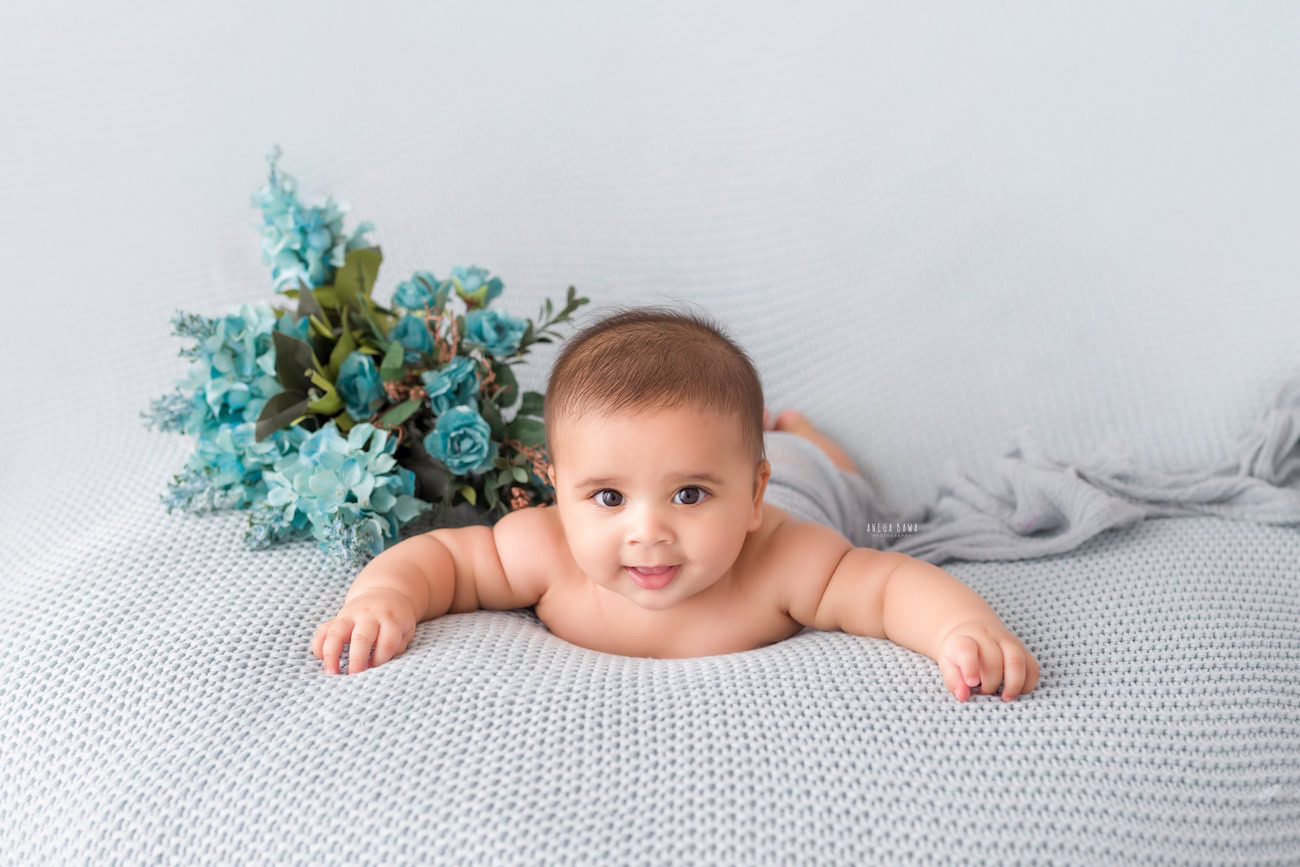 Baby boy photographer, 6, 4, 3, or 5 months, grey sheet, blue flowers. Location: Delhi, Gurgaon, Noida. Photographer: Anega Bawa.