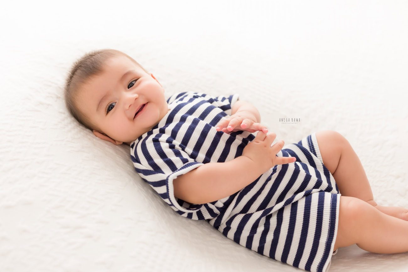 Baby boy photographer, 6 or 4 or 3 or 5 months, white backdrop. Location: Delhi, Gurgaon, Noida. Photographer: Anega Bawa.
