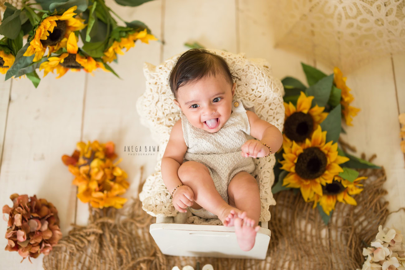 baby-boy-photography-5-4-3-6-months-beige-backdrop-brown-rug-yellow-and-orange-flowers-delhi-gurgaon-noida-anega-bawa