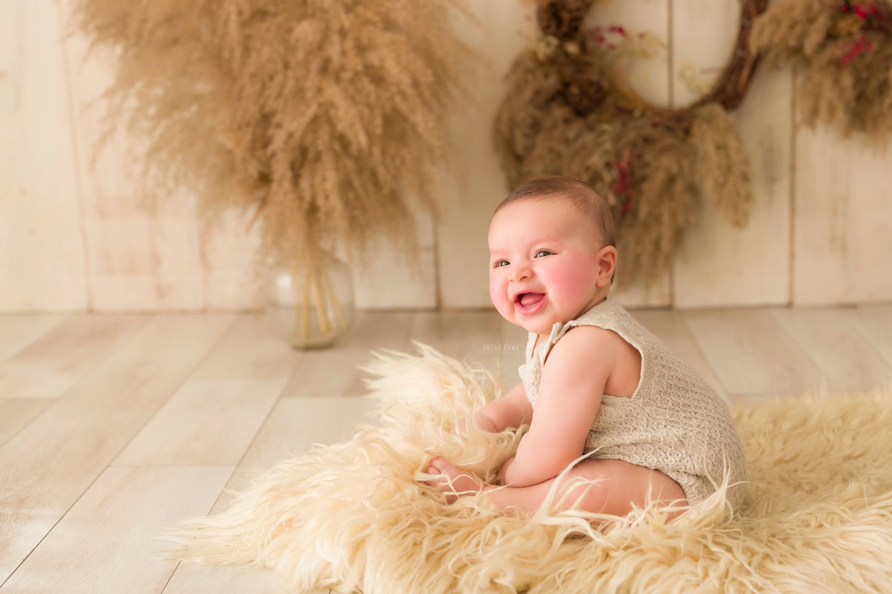 Baby boy photography, 5, 4, 3, or 6 months, beige rug, beige backdrop, shrubs. Location: Delhi, Gurgaon, Noida. Photographer: Anega Bawa.