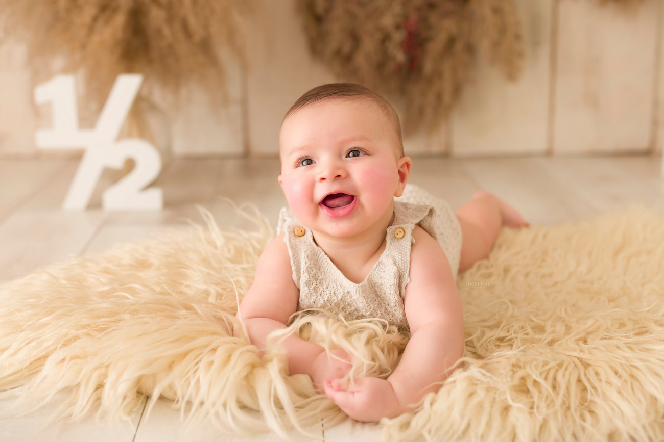 Baby boy photography, 5, 4, 3, or 6 months, beige rug, cute smiling pose. Location: Delhi, Gurgaon, Noida. Photographer: Anega Bawa.