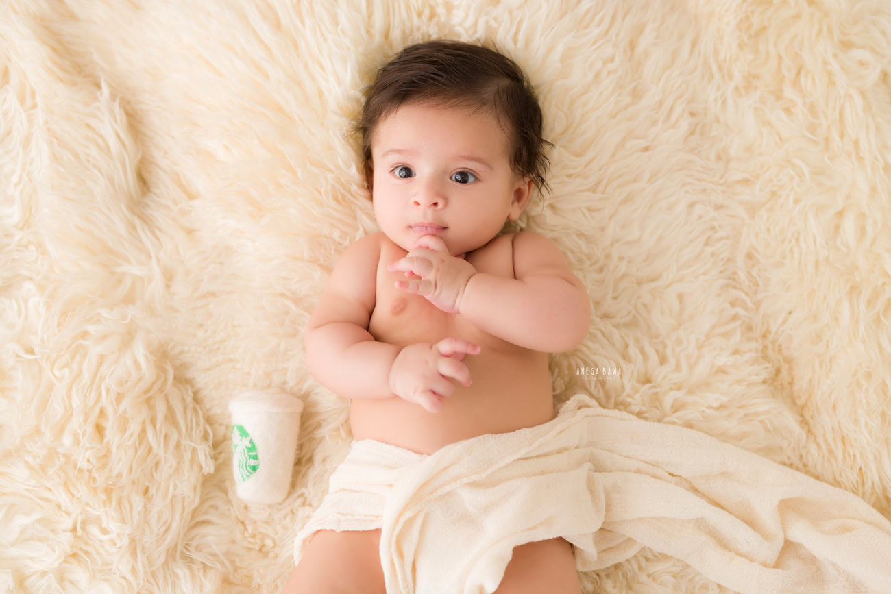 Baby boy photography, 5 or 4 or 3 or 6 months, beige rug, cute Starbucks glass. Location: Delhi, Gurgaon, Noida. Photographer: Anega Bawa.