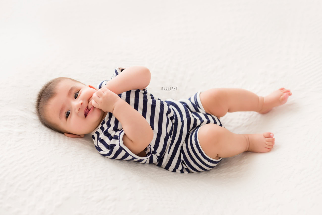 Baby boy photography, 5 or 4 or 3 or 6 months, blue and white baby boy suit, white backdrop. Location: Delhi, Gurgaon, Noida. Photographer: Anega Bawa.