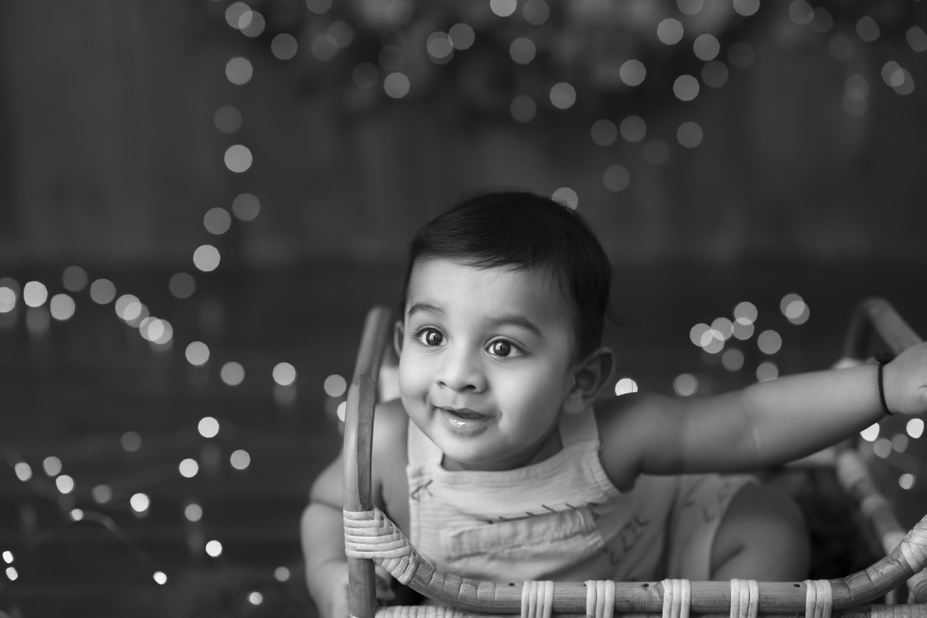 Capture the playful spirit of your 5, 4, 3, or 6-month-old baby boy against a backdrop of rich brown and golden hues, with a timeless black and white theme. Book now with Anega Bawa in Delhi, Gurgaon, or Noida.
