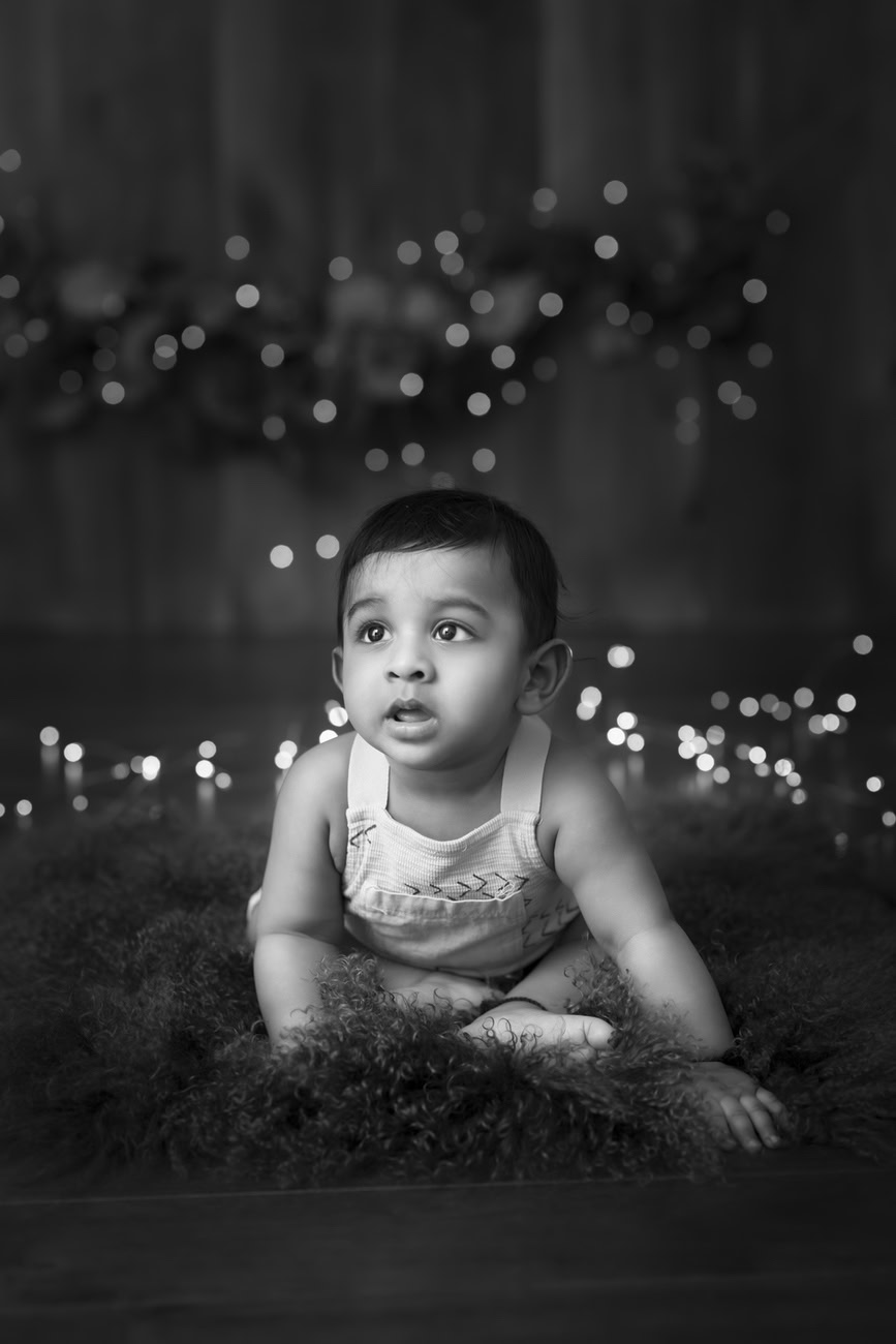 Capture the playful spirit of your 5, 4, 3, or 6-month-old baby boy against a backdrop of rich brown and golden hues, with a timeless black and white theme. Book now with Anega Bawa in Delhi, Gurgaon, or Noida.