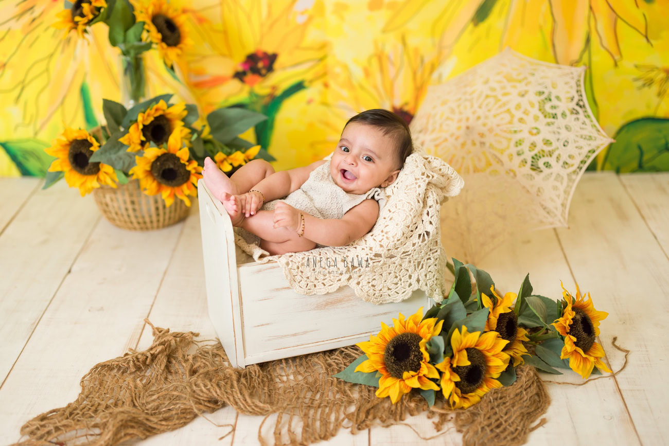 Baby boy photography, 5, 4, 3, or 6 months, brown rug, sunflower backdrop, net umbrella. Location: Delhi, Gurgaon, Noida. Photographer: Anega Bawa.