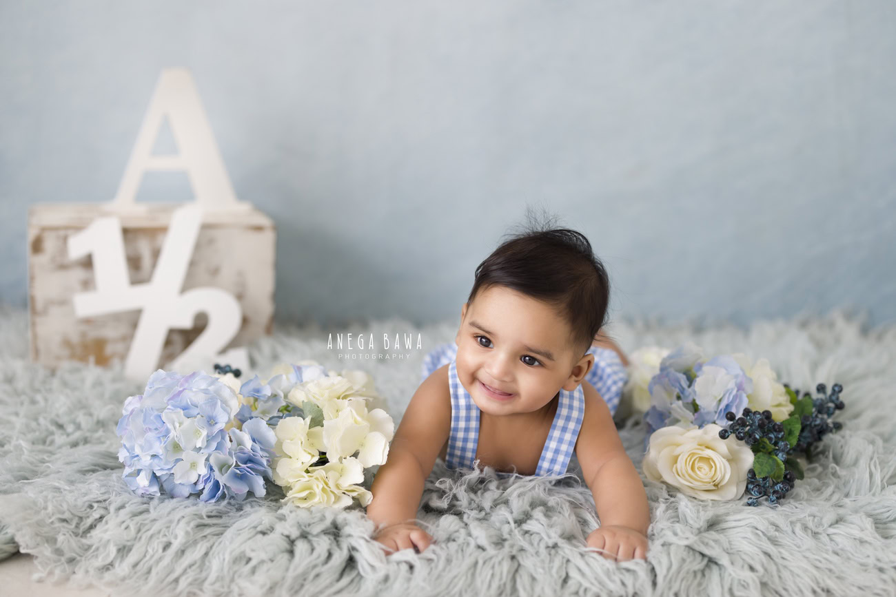 Create timeless memories of your little one, aged 3, 4, 5, or 6 months, with Anega Bawa's captivating baby boy photography services in Delhi, Gurgaon, or Noida. Featuring a serene grey rug adorned with delicate blue and white flowers, capture the essence of innocence and charm against a backdrop of tranquility.