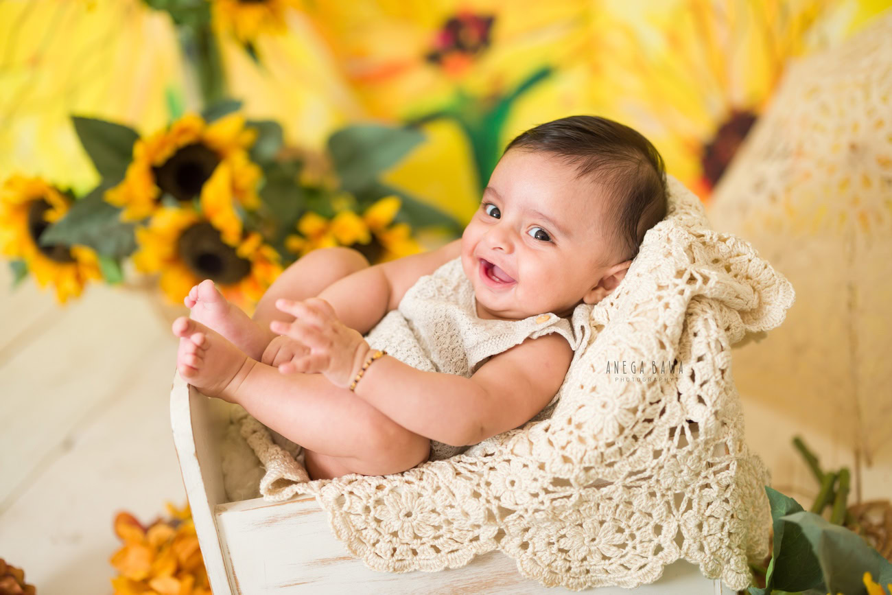 Baby boy photography, 5, 4, 3, or 6 months, white wooden basket, yellow sunflower. Location: Delhi, Gurgaon, Noida. Photographer: Anega Bawa.