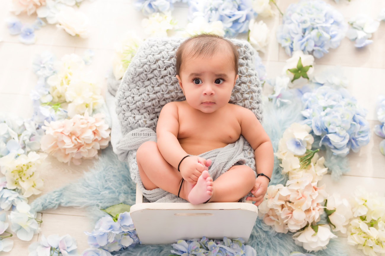 Baby boy photography, 5 or 4 or 3 or 6 months, white wooden chair, grey wrap, beige backdrop. Location: Delhi, Gurgaon, Noida. Photographer: Anega Bawa.