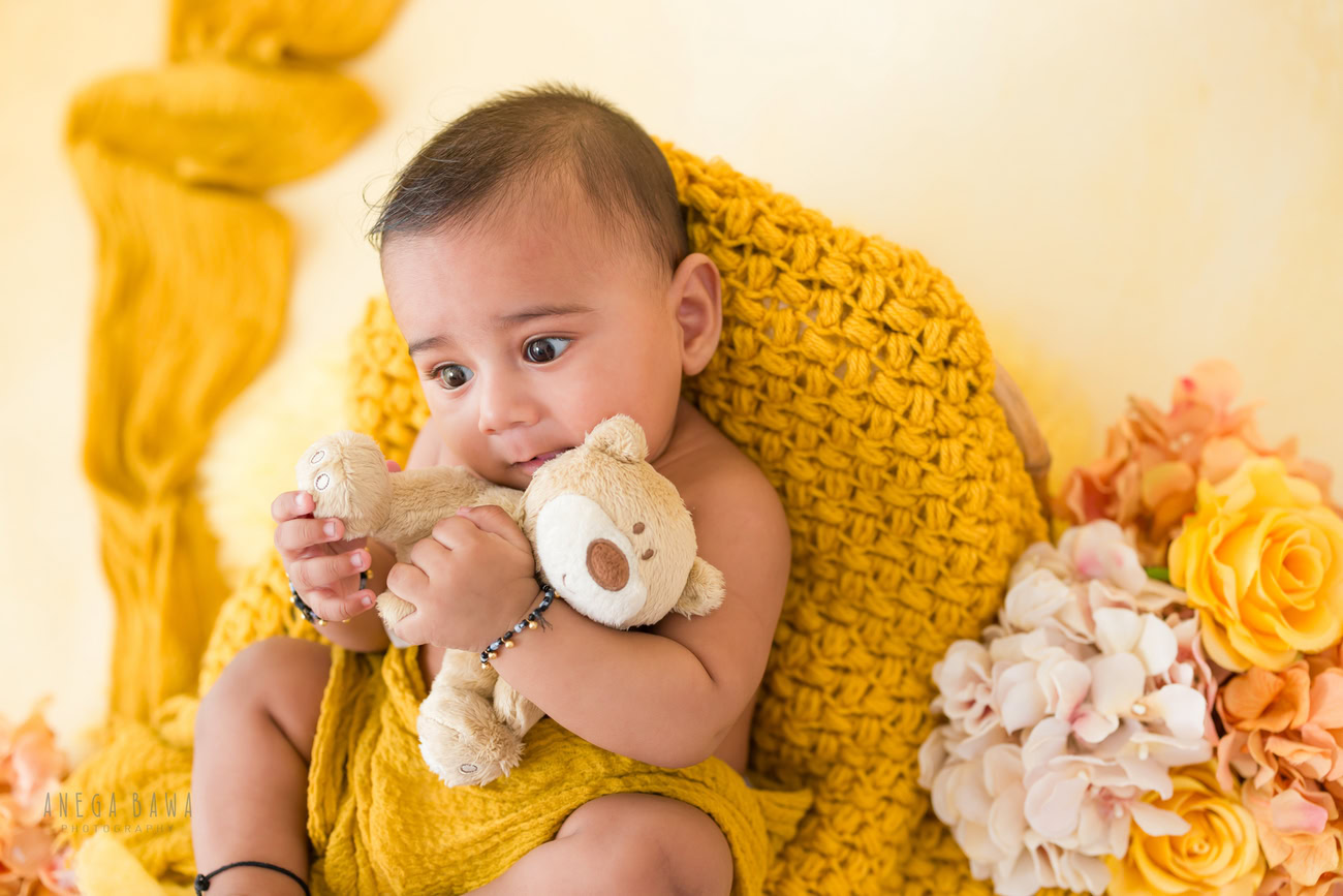Baby boy photography, 5 or 4 or 3 or 6 months, yellow wrap, light yellow backdrop, soft toy. Location: Delhi, Gurgaon, Noida. Photographer: Anega Bawa.