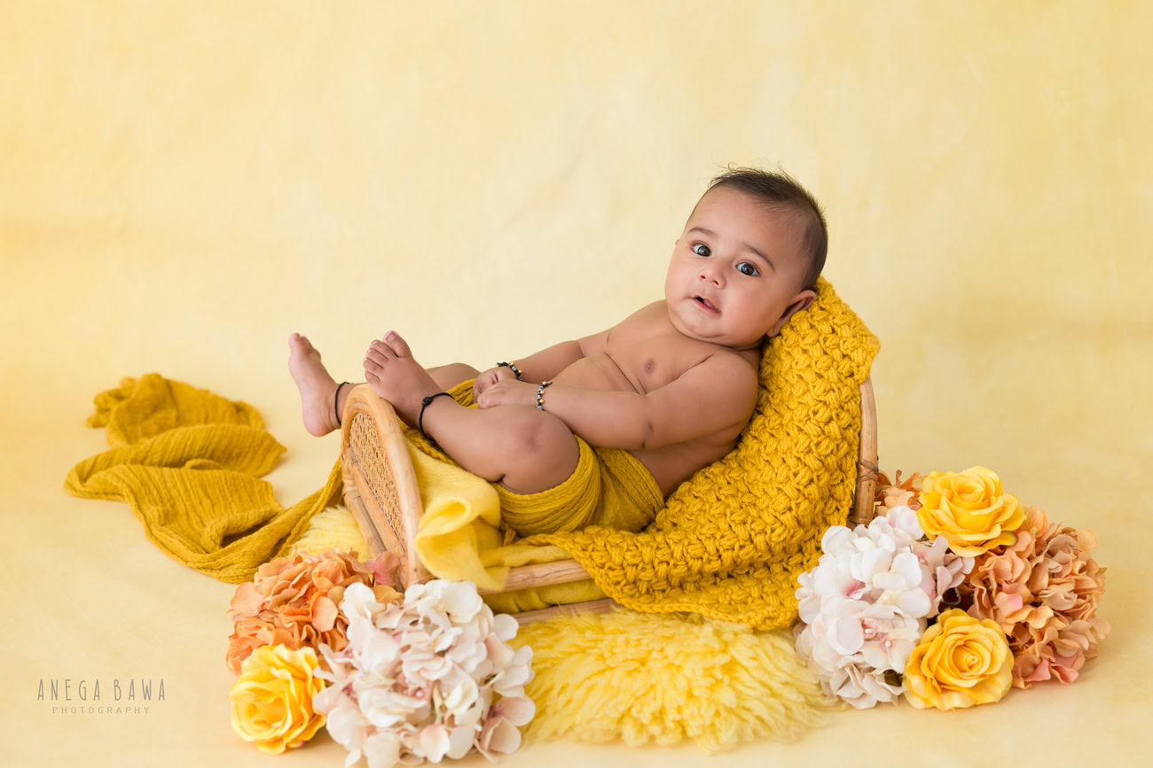 Baby boy photography, 5 or 4 or 3 or 6 months, yellow wrap, yellow backdrop, cute seating pose. Location: Delhi, Gurgaon, Noida. Photographer: Anega Bawa.