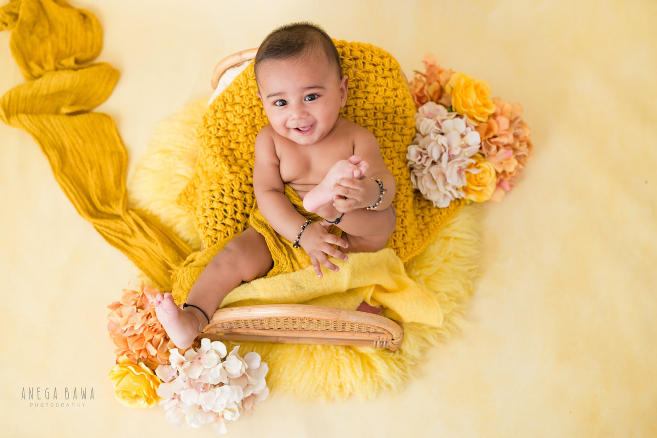 Baby boy photography, 5 or 4 or 3 or 6 months, yellow wrap, yellow backdrop. Location: Delhi, Gurgaon, Noida. Photographer: Anega Bawa.
