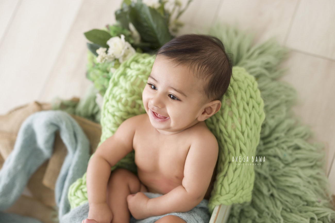 Baby boy photoshoot, 6, 5, 4, 3 months, beige backdrop, blue wrap, green rug. Location: Delhi, Gurgaon, Noida. Photographer: Anega Bawa.
