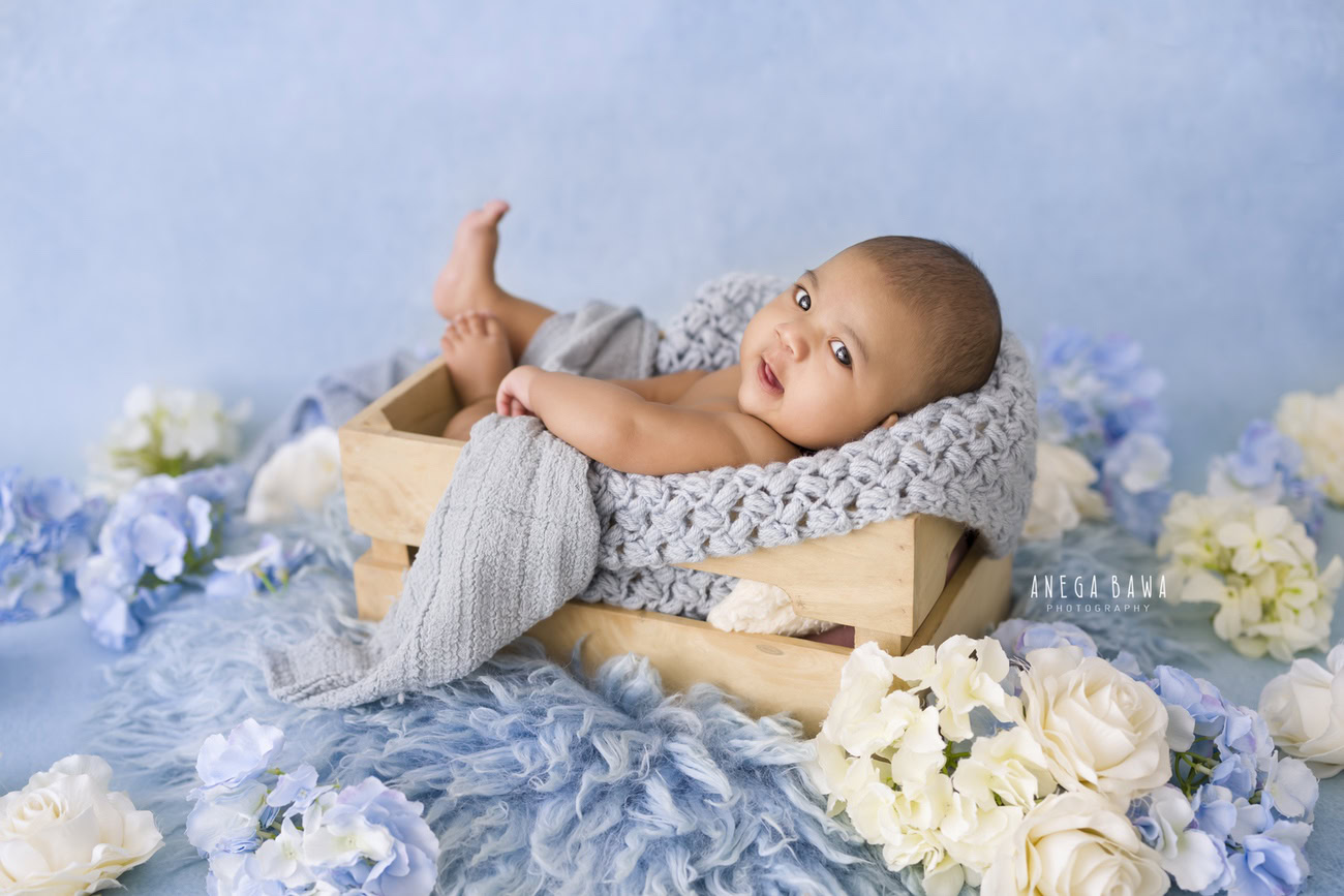 Capture the innocence and charm of your little one with a baby boy photoshoot at 3, 4, 5, or 6 months old. Adorned with a blue wrap and lying on a cozy blue rug against a serene blue backdrop, your baby's precious moments are beautifully framed. Contact Anega Bawa for an unforgettable experience in Delhi, Gurgaon, or Noida.