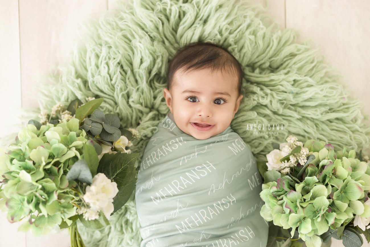 Baby boy photoshoot, 6, 5, 4, 3 months, green wrap, green rug, beige backdrop. Location: Delhi, Gurgaon, Noida. Photographer: Anega Bawa.