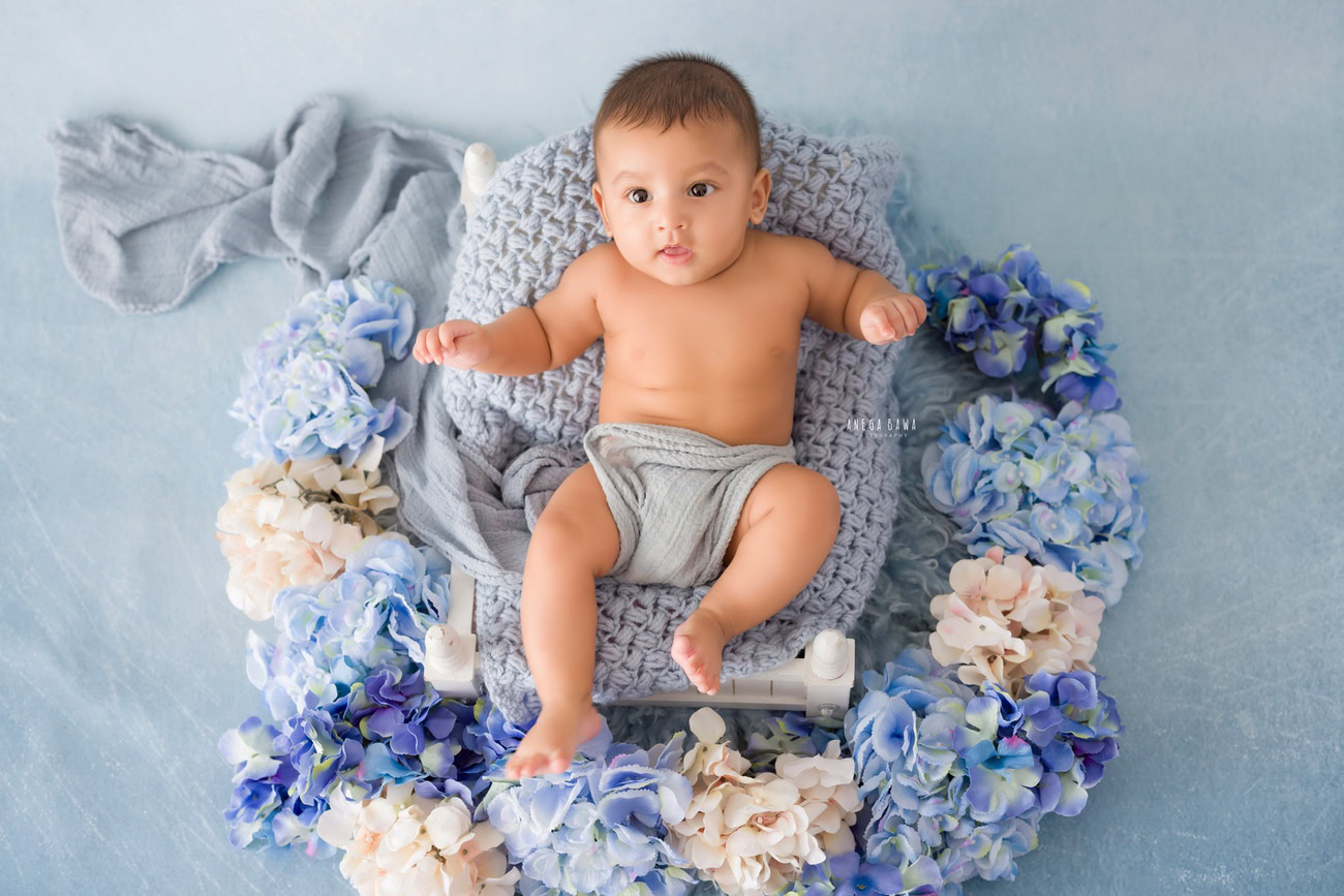 Baby boy photoshoot, 6 or 5 or 4 or 3 months, grey backdrop, floral curve, grey wrap. Location: Delhi, Gurgaon, Noida. Photographer: Anega Bawa.