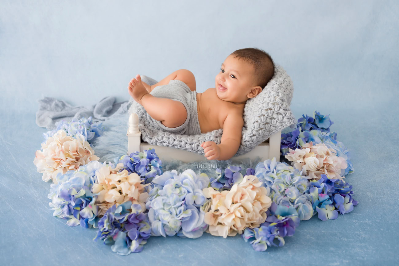 Baby boy photoshoot, 6 or 5 or 4 or 3 months, grey backdrop, grey wrap, floral curve. Location: Delhi, Gurgaon, Noida. Photographer: Anega Bawa.