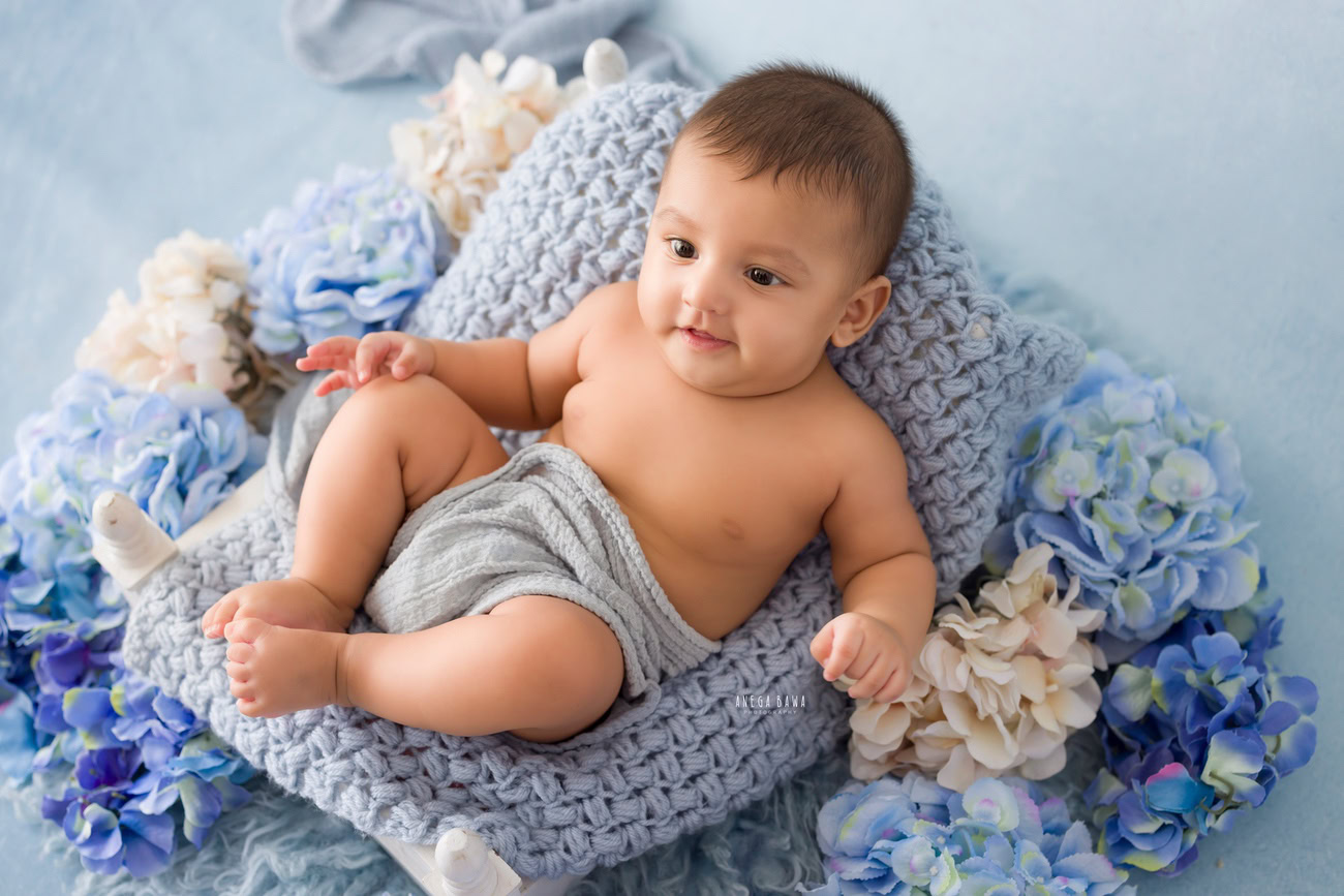 Baby boy photoshoot, 6 or 5 or 4 or 3 months, grey backdrop, grey wrap, flowers. Location: Delhi, Gurgaon, Noida. Photographer: Anega Bawa.