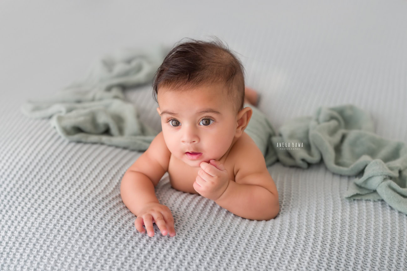 Baby boy photoshoot, 6 or 5 or 4 or 3 months, grey sheet, grey backdrop. Location: Delhi, Gurgaon, Noida. Photographer: Anega Bawa.