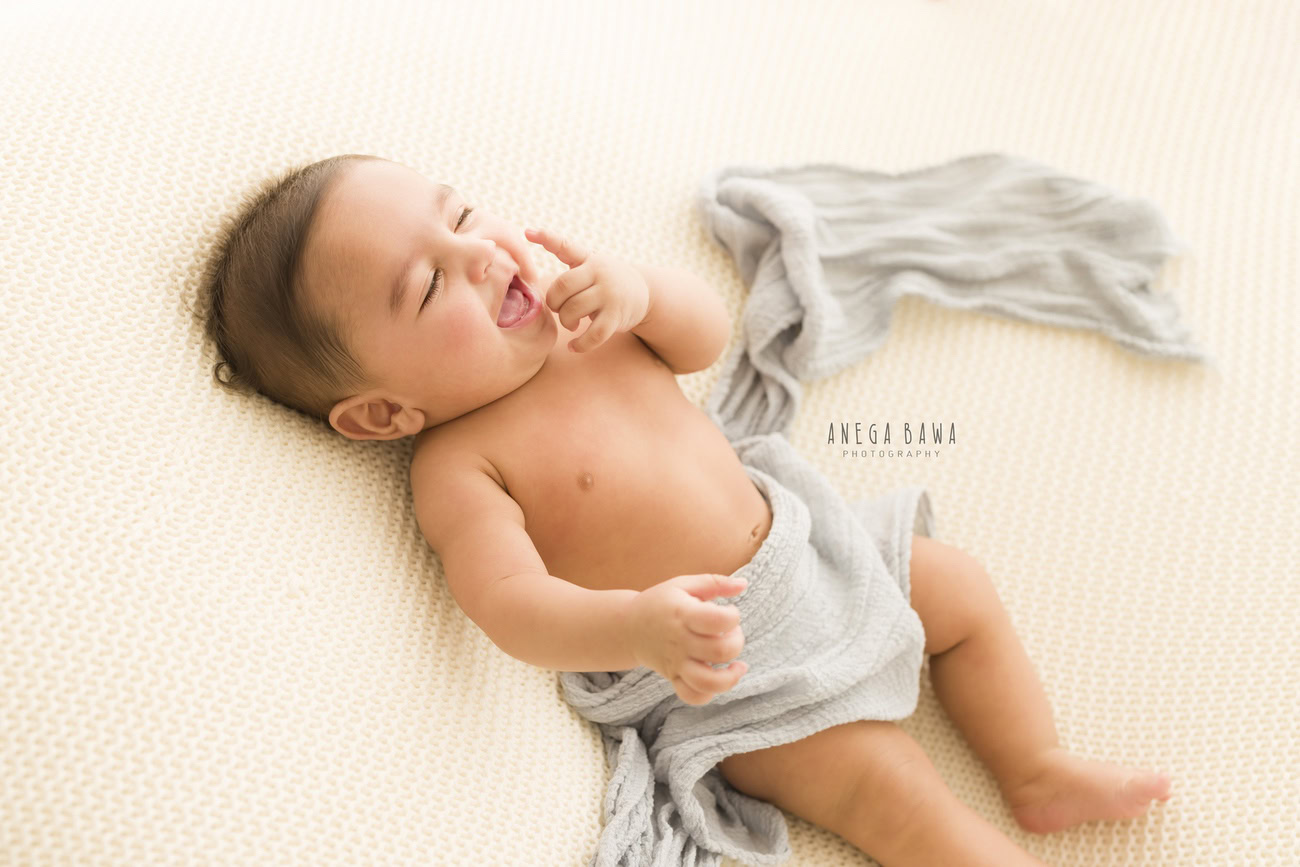 Baby boy photoshoot, 6, 5, 4, 3 months, white backdrop, grey wrap, cute smiling pose, Delhi, Gurgaon, Noida, Anega Bawa.