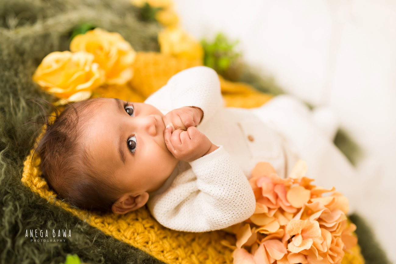 Dress your little prince in a pristine white suit and let him shine against a vibrant yellow and green backdrop. Contact Anega Bawa for a delightful baby boy photoshoot in Delhi, Gurgaon, or Noida.