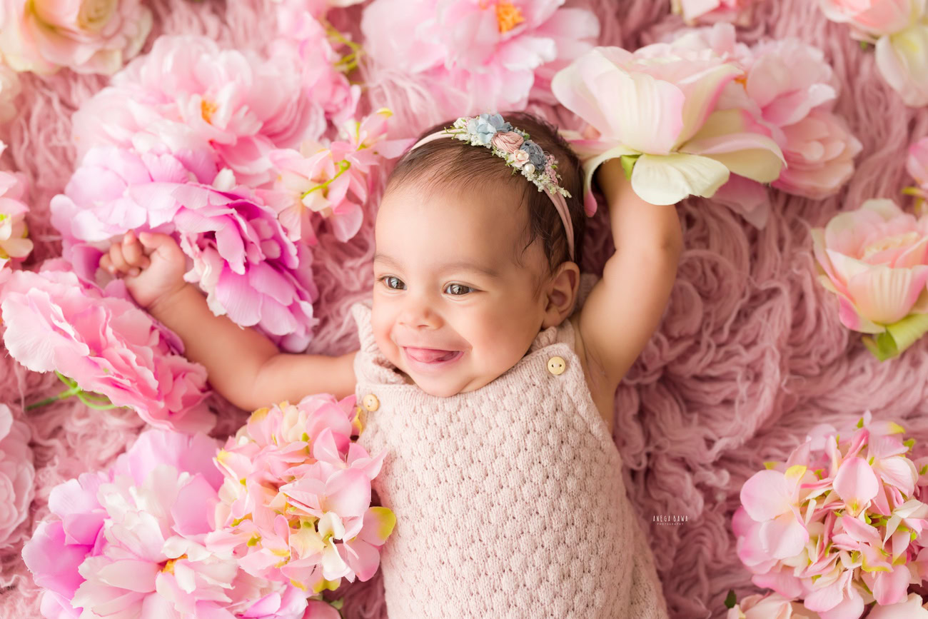 Baby girl photo shoot, 6 or 5 or 3 or 4 months, pink baby suit, cute headband, floral backdrop. Location: Delhi, Gurgaon, Noida. Photographer: Anega Bawa.