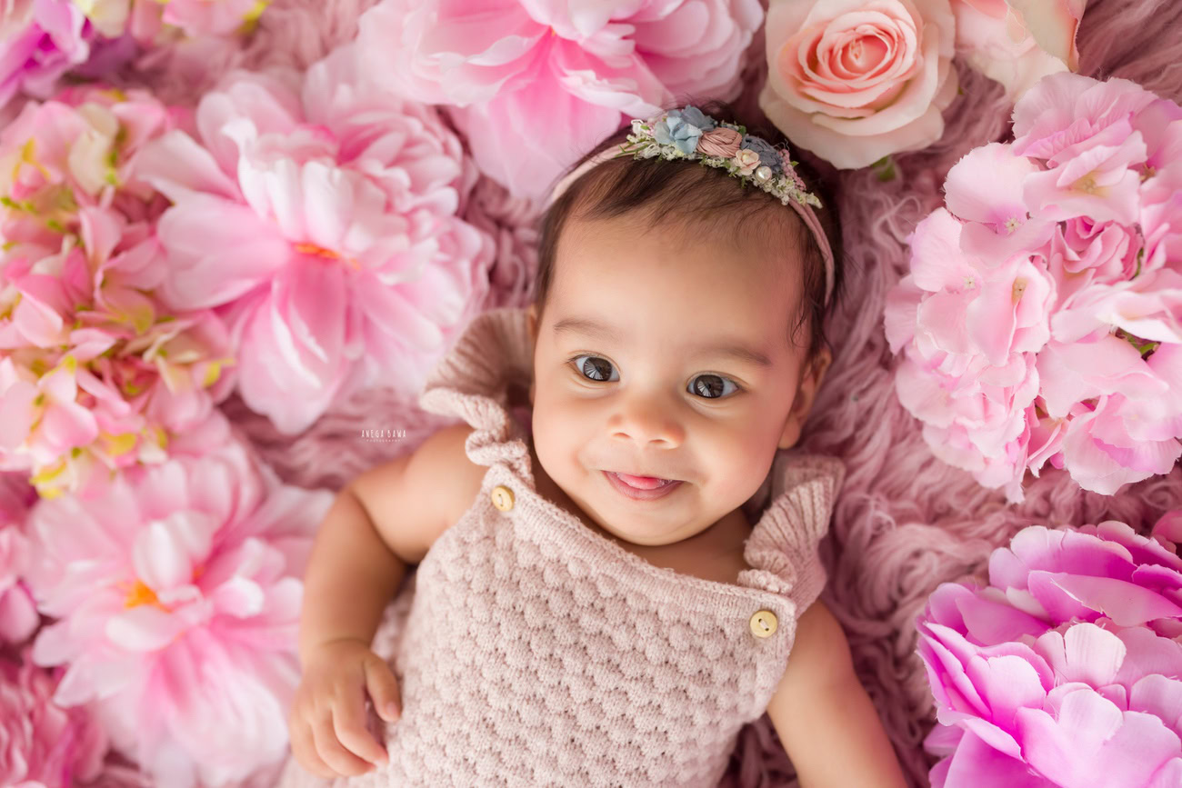 Baby girl photo shoot, 6 or 5 or 3 or 4 months, pink floral backdrop, cute headband. Location: Delhi, Gurgaon, Noida. Photographer: Anega Bawa.