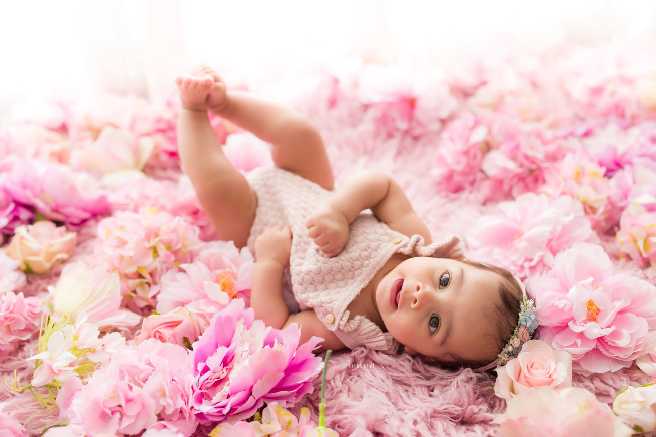 Baby girl photo shoot, 6 or 5 or 3 or 4 months, white backdrop, pink flowers on floor, white backdrop. Location: Delhi, Gurgaon, Noida. Photographer: Anega Bawa.