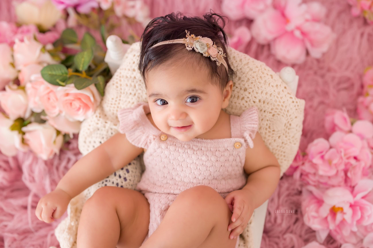 baby-girl-photographer-3-4-5-6-months-pink-rug-pink-flowers-backdrop-delhi-gurgaon-noida-anega-bawa