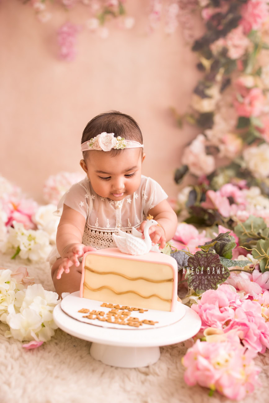 Capture the precious moments of your baby girl's growth with a delightful photoshoot! Featuring a peach backdrop embellished with multicolored flowers, this session includes a playful cake smash to mark the occasion. Book your session with Anega Bawa for this memorable experience in Delhi, Gurgaon, or Noida.