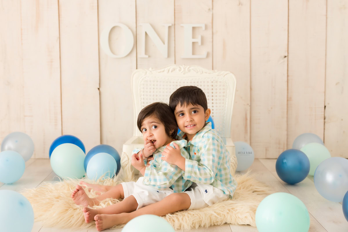In this heartwarming capture from a baby pre-birthday photoshoot in Delhi by Anega Bawa, two siblings share a tender hugging pose. Against a backdrop adorned with balloons, the 11-month-old and 1-year-old boys exude joy and affection, creating a memorable moment filled with warmth and sibling love.