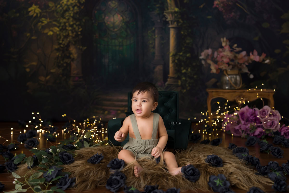 Nestled on a soft brown rug, the 12-month-old boy sits serenely amidst a golden brown backdrop adorned with twinkling fairy lights. This enchanting scene captures the essence of innocence and wonder during his baby pre-birthday photoshoot. Anega Bawa's artistry in Delhi, Gurgaon, and Noida immortalizes this precious moment, preserving the magic of childhood for years to come.