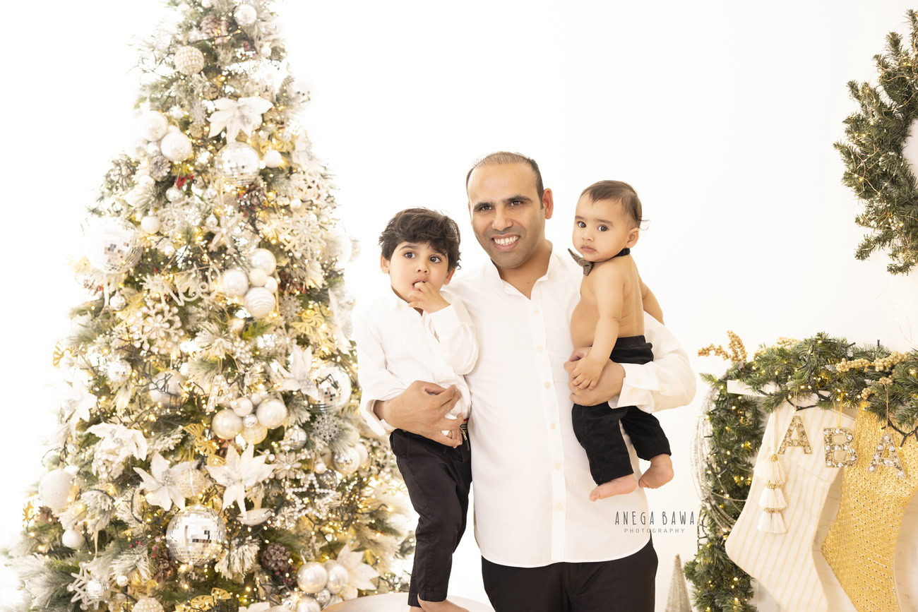 Create heartwarming memories this holiday season with Anega Bawa Photography in Delhi and Gurgaon. Dress your baby and sibling in festive attire, pose them with a Christmas tree and Santa boots against a pristine white backdrop, and capture the joy and magic of the season with your family.
