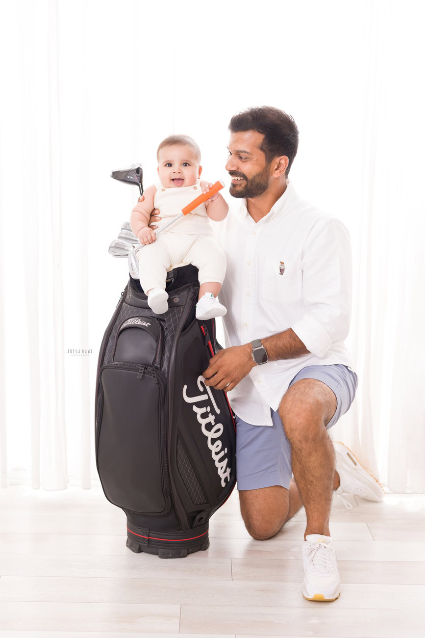 Create lasting memories with Anega Bawa Photography in Delhi and Gurgaon as Dad and daughter strike a pose on a gym bag against a pristine white backdrop. Cherish these precious moments forever.