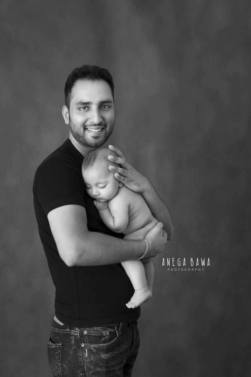 In the serene ambiance of Delhi and Gurgaon, Anega Bawa Photography captures the tender moment of a father and his son in a sweet hugging pose against a soft grey backdrop. It's a timeless expression of love and connection, preserved beautifully by Anega Bawa's lens.