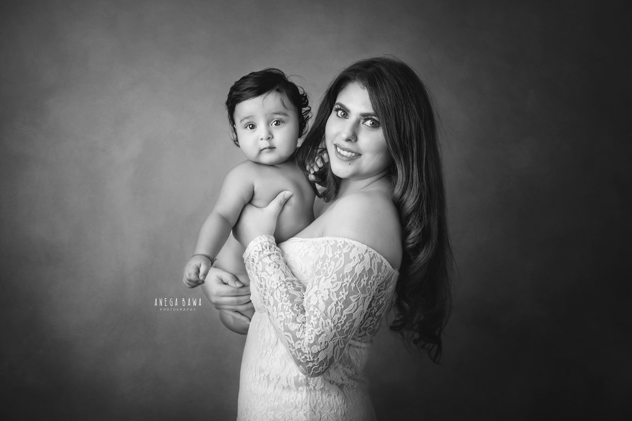 Captivating family photoshoot by Anega Bawa Photography, celebrated in Delhi and Gurgaon, featuring Mom and son against a timeless black-and-white backdrop.