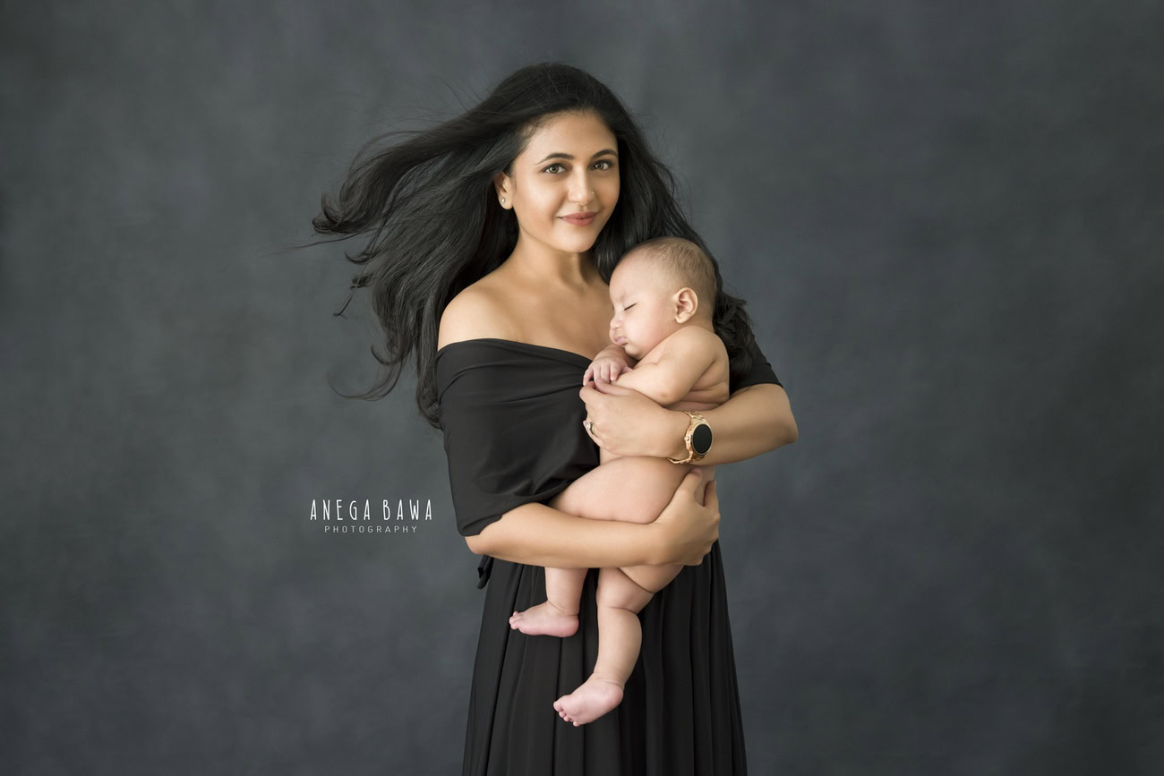 Delhi and Gurgaon's renowned Anega Bawa Photography captures the essence of family love with a delightful photoshoot featuring Mom and son in a charming duo against a stylish grey backdrop.