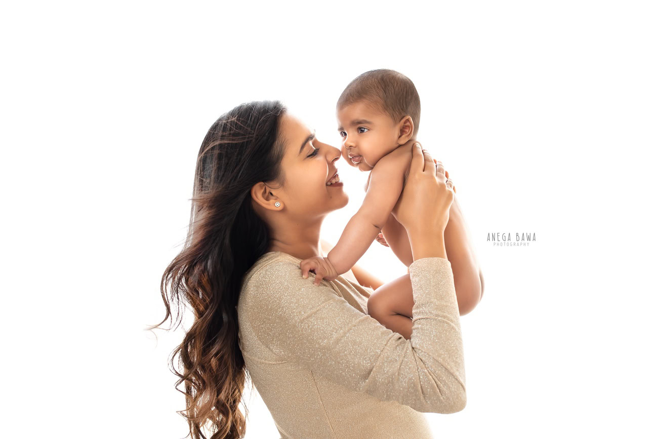 Celebrate the bond between mother and son with a heartwarming family photoshoot against a clean white backdrop, courtesy of Anega Bawa Photography in Delhi and Gurgaon. Capture the joy and love shared between them in timeless images to be treasured forever.