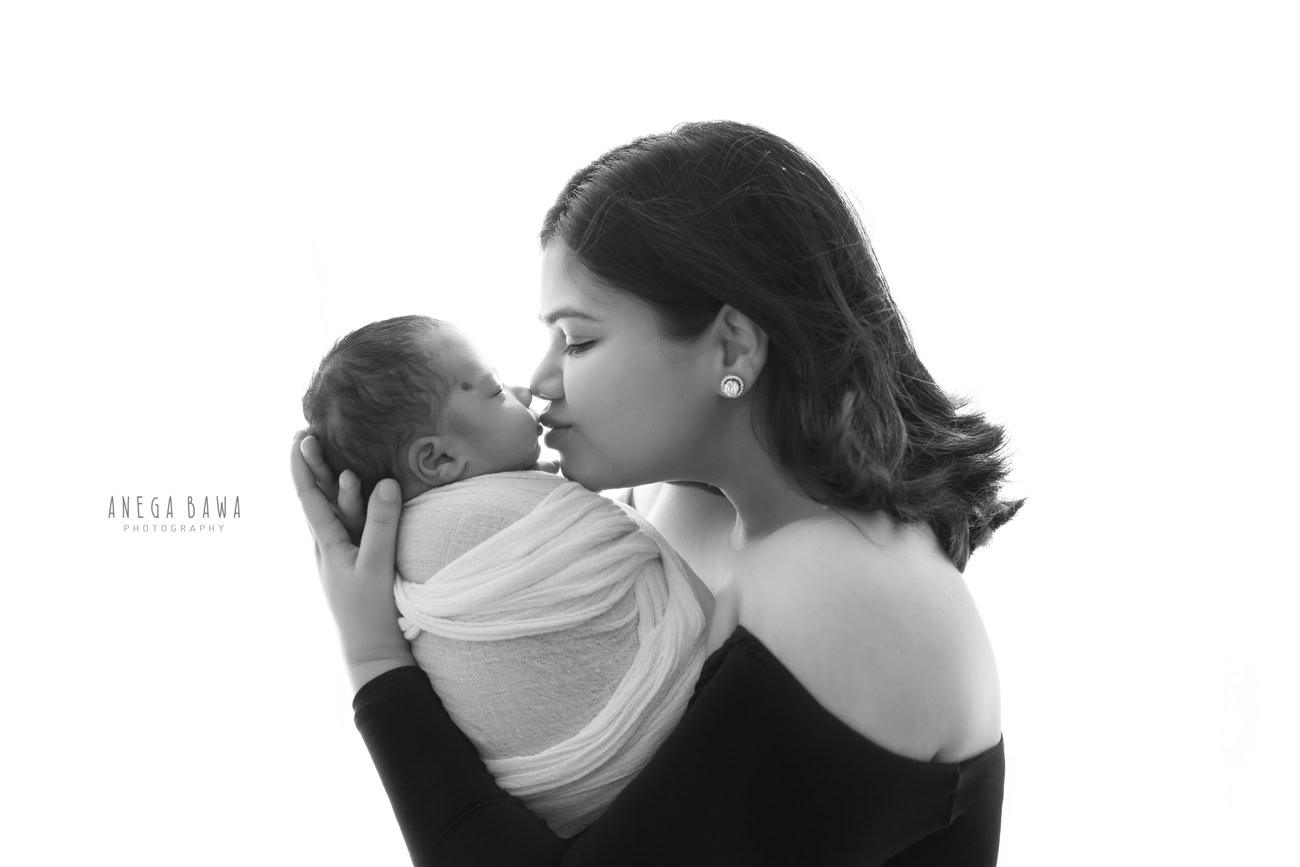 Experience the purest love between mother and son in a captivating family photoshoot captured by Anega Bawa Photography against a pristine white backdrop in Delhi and Gurgaon. Wrapped in serenity and warmth, cherish these moments for a lifetime.