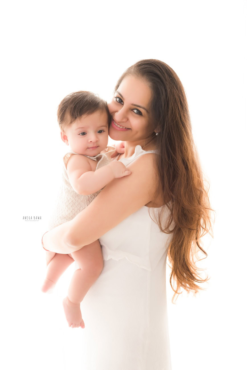 Celebrate the beautiful bond between a mother and her son with a heartwarming family photoshoot by Anega Bawa Photography in Delhi and Gurgaon. Capture the tender moments as Mumma embraces her son lovingly against a pristine white backdrop, creating timeless memories that will be cherished forever.