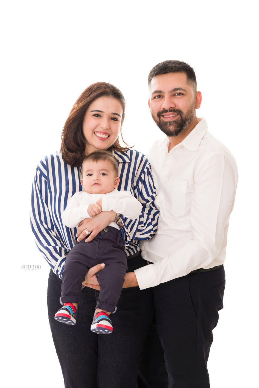 Capture the joy of parenthood with Anega Bawa Photography in Delhi and Gurgaon. Let Mumma and Papa strike adorable poses with their son against a pristine white backdrop. These heartwarming moments will be cherished forever.