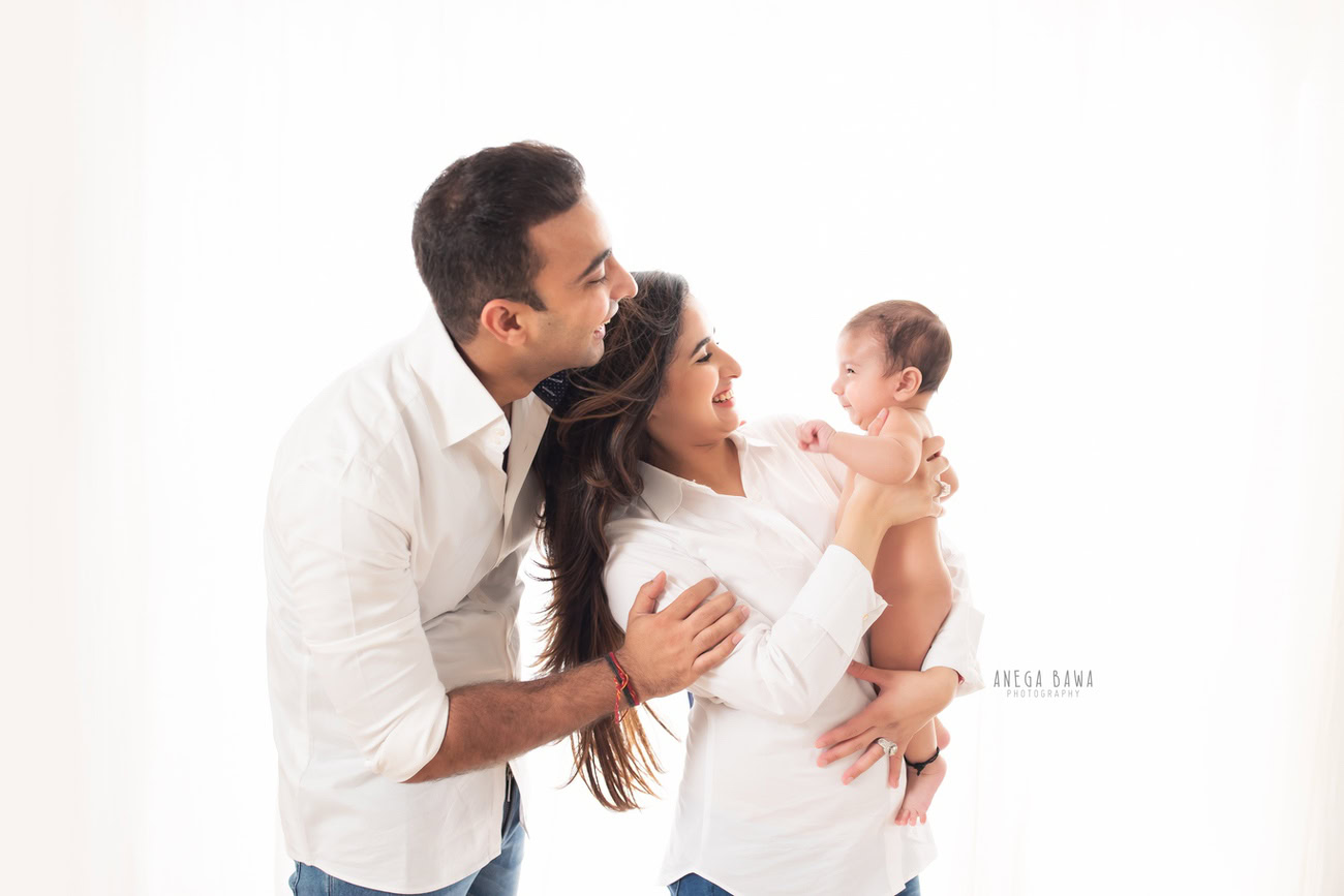 Capture precious family moments with Anega Bawa Photography in Delhi and Gurgaon. Let Mumma, Papa, and Son strike a cute smiling pose against a pristine white backdrop, creating timeless memories that you'll cherish forever.