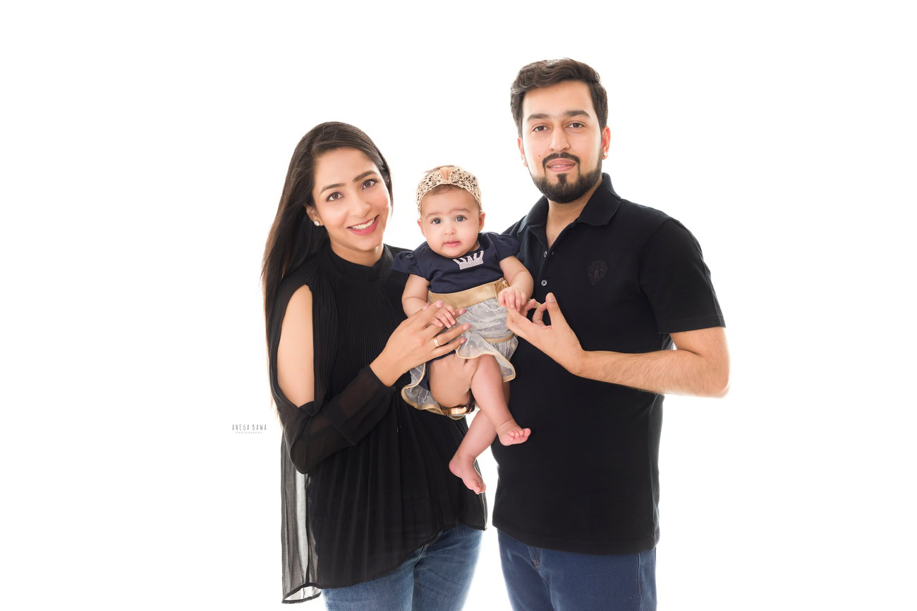 Create precious memories with Anega Bawa Photography in Delhi and Gurgaon as you pose with your darling daughter against a pristine white backdrop. Let the love and joy your family shares shine through in every frame, capturing the beauty of these fleeting moments together.