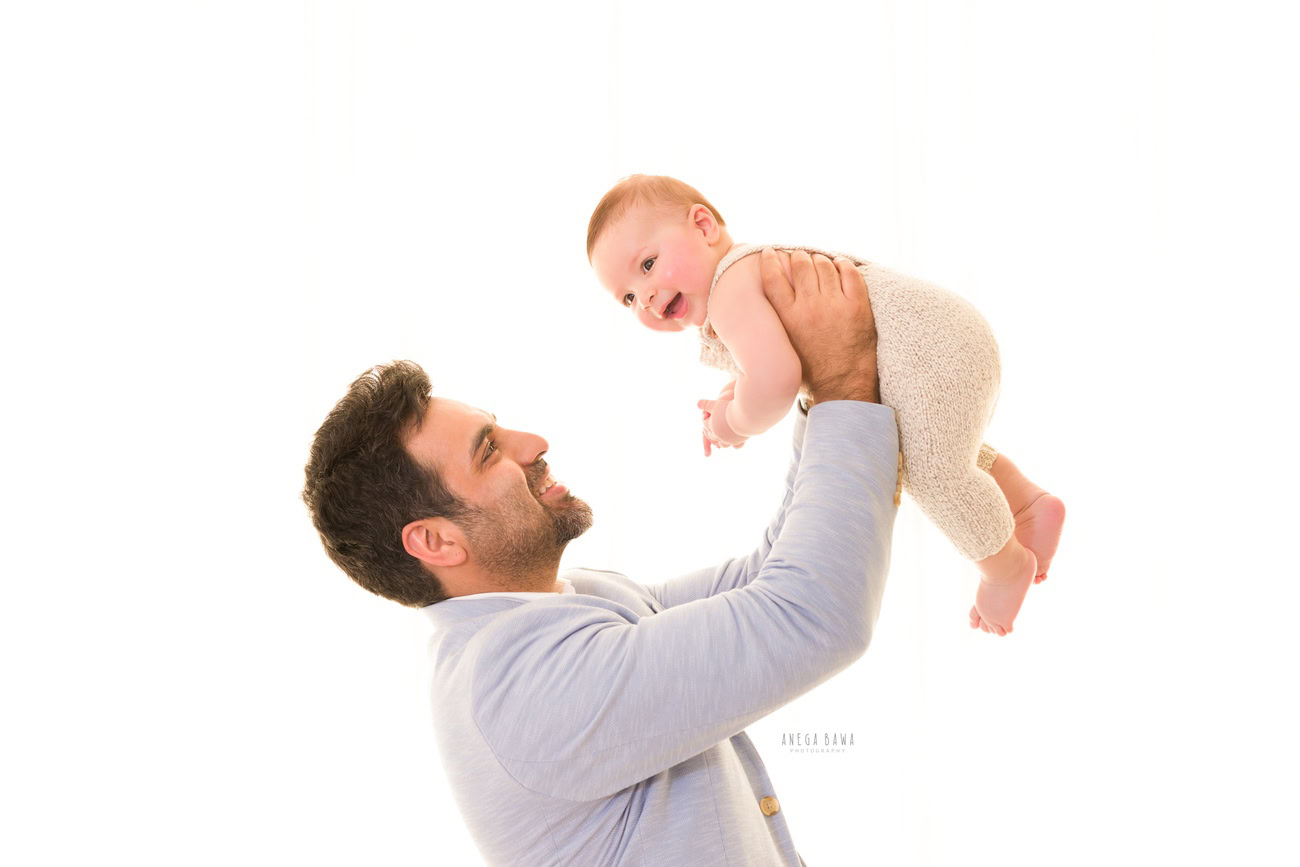 Capture the heartwarming moments of Papa playing with his son against a clean white backdrop with Anega Bawa Photography in Delhi and Gurgaon. These playful interactions between father and son create memories that will be cherished for years to come.