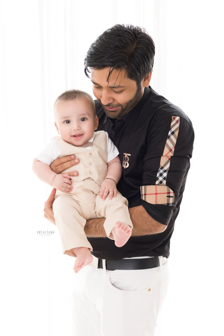 For a timeless family portrait, envision Papa and his son dressed in coordinated beige pant suits against a pristine white backdrop. Anega Bawa Photography in Delhi and Gurgaon can expertly capture this classic moment, ensuring that every smile and glance is preserved for years to come.