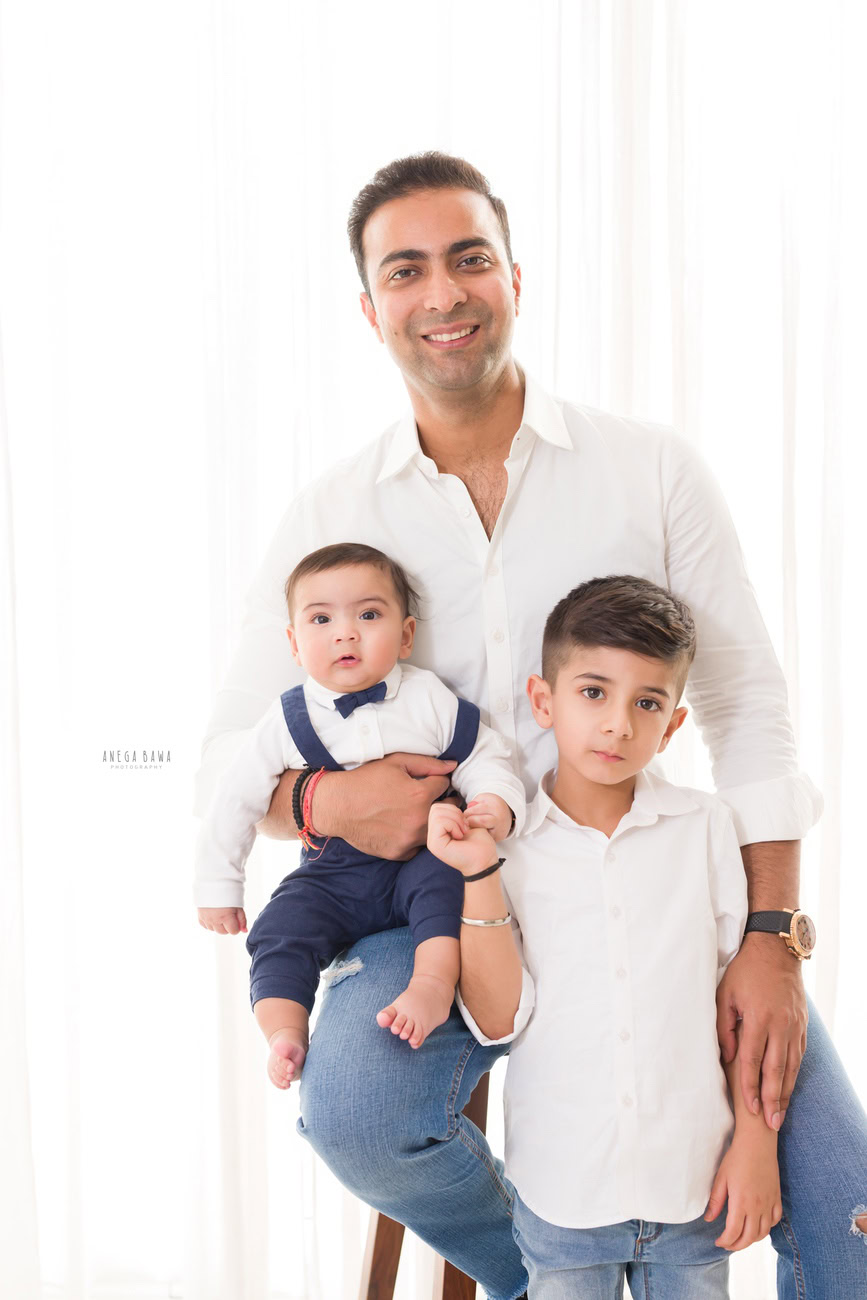 Capturing the bond between father and son during the early months is priceless. Imagine a family photoshoot where the baby son sits on his papa's lap, perhaps with a sibling nearby, all against a clean white backdrop. Anega Bawa Photography in Delhi and Gurgaon can beautifully immortalize this moment, ensuring it becomes a cherished memory for the family.