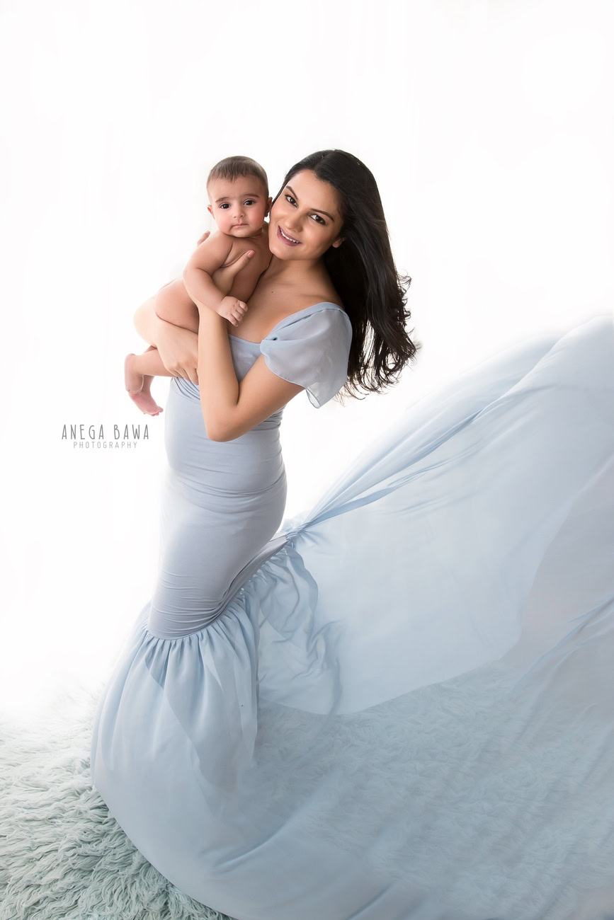 A family photoshoot featuring a mom in a sky-blue gown and her son against a white backdrop sounds enchanting. Anega Bawa Photography in Delhi and Gurgaon is adept at capturing the essence of such moments with finesse and creativity. They ensure that the bond between mother and son is beautifully portrayed, creating timeless memories for your family.